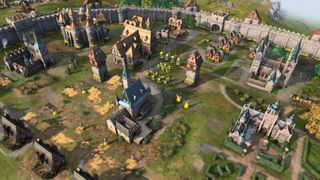 By i Age of Empires IV med flere bygninger og enheter.