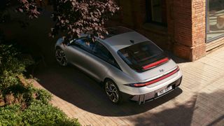 The Ioniq 6 parked in a leafy parking space on a sunny day