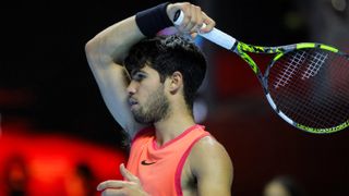 Spain's Carlos Alcaraz, wearing a red tennis vest, plays a shot ahead of his appearance at the Paris Masters 2024 tournament 