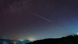 a streak of light crosses the night sky