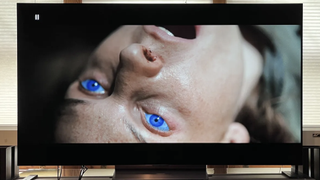 The LG C4 TV showing a scene from Dune 2 of a character with bright blue eyes and their head thrown back.