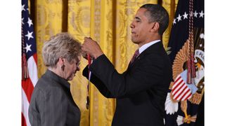 Sandra Faber on the left is preparing to receive a medal from Barack Obama (right).