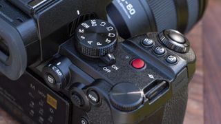 Panasonic Lumix S5 II camera on a table with close up of the on off switch and video record button