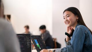 Female developer designing an iOS app on a MacBook