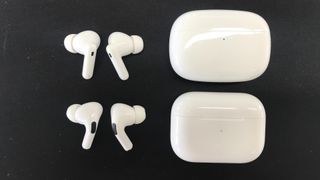 Apple AirPods Pro and Honor Earbuds 3 Pro on black background