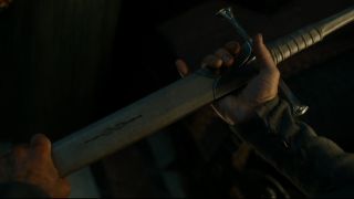 A screenshot of Elendil's hands holding Narsil in The Rings of Power season 2 episode 8