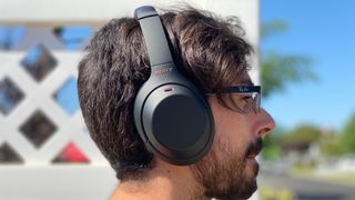 A man wearing a pair of the sony wh-1000xm4 headphones