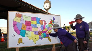 A visitor adds a pin to a map displaying where eclipse seekers are visiting from during the town's celebration of the April 8 solar eclipse on April 07, 2024 in Russellville, Arkansas. Communities across the country in the path of totality of the April 8 eclipse are holding festivals and preparing to host a massive influx of visitors to view the rare celestial phenomenon.