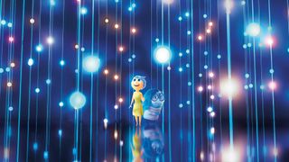 Joy and Sadness animated characters from Inside Out surrounded by glowing lights