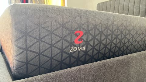 Zoma Hybrid mattress photographed from the side in reviewer&#039;s bedroom