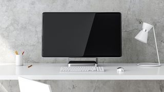 An all-in-one PC on a minimilast desk