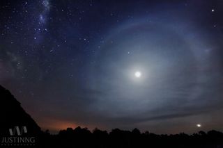 Justin Ng of Singapore captured this composite image of the Milky Way and a lunar halo over Mersing, Malaysia. Planet Venus appears to the bottom right of the image with planet Saturn near the top of the moon. The fourth brightest star in the night sky, Arcturus, is seen near the top right corner of the photo. The image was released Aug. 14, 2013.