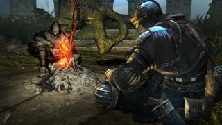 Two players by a campfire during Dark Souls, one of the best PS3 games.