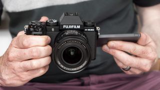 Fujifilm X-S20 camera in hand