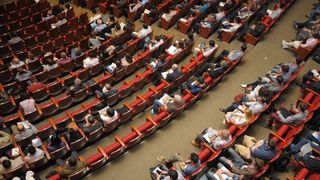 People sat at a conference event.