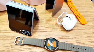 Samsung Galaxy Watch 7 next to Galaxy Flip 6 and Galaxy Buds Pro 3