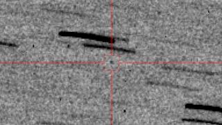 black-and-white telescope photo of blurry, pixelated stars