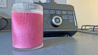 frozen berry smoothie in a glass on the countertop