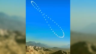 Artist's illustration of an analemma in the sky. Each point of light demonstrates a "snapshot" image of the sun's position in the sky. When displayed together all the points of light look like a lopsided figure of eight stretching across the blue sky.