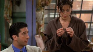 Monica and Ross sit on the couch in the sitcom Friends