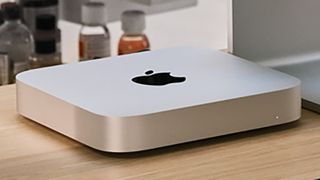 The Mac mini 2023 on a desk next to a monitor