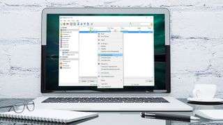 A laptop on a desk, displaying qBittorrent, one of the best free torrent clients