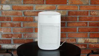 How to clean a dehumidifier: Image shows dehumidifier against brick wall