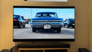 A scene from KAOS on Netflix showing the rear of an American muscle car