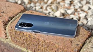 Motorola Moto G82 back on brick wall angled view