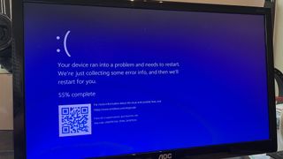 Blue screen of death pictured on a PC screen after failed Windows update showing restart loop.