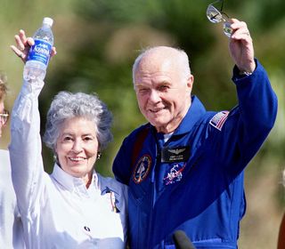 Astronaut John Glenn (R) and his wife Annie wave to friends at the Kennedy Space Center, FL 08 November as the crew of the Shuttle Discovery prepared to fly to Johnson Space Center in Houston.