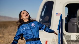 Emily Calandrelli celebrates in front of the Blue Origin capsule after becoming the 100th woman in space. 