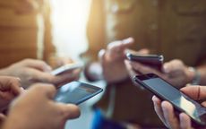 Cropped shot of a group of colleagues using their smart phones in synchronicity