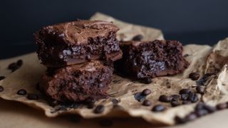 Cholate brownies on parchment paper surrounded by chocolate chips