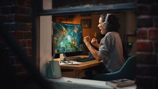 Cheerful Female Gamer Playing Online Video Game on Personal Computer