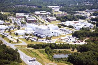 aerial view of buildings surrounded by grass and trees