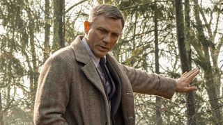 Daniel Craig holding hand out as Benoit Blanc in Knives Out