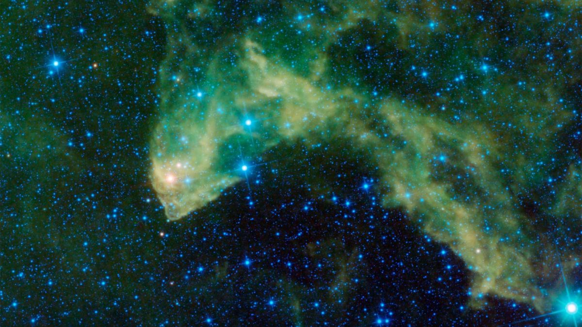 spacecraft photo of a huge green nebula in deep space, with lots of bright stars in the background