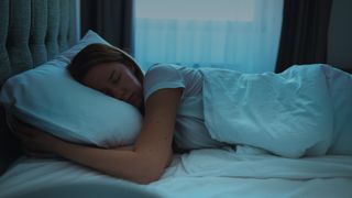 A person in deep sleep, lying in bed