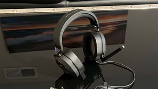 best PC gaming headsets Corsair HS65 Surround on a reflective black table