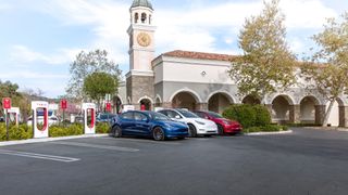 Three Tesla electric cars parked next to each other at a Supercharger location