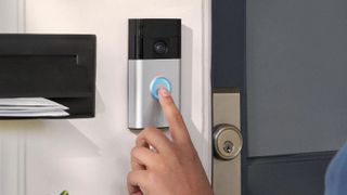 Person pressing Ring Battery Doorbell button