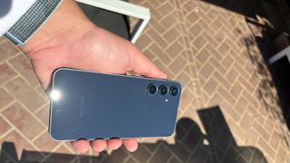 Samsung Galaxy A55's rear glass shining in the midday sun