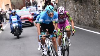 Kometa Cycling Team&#039;s Samuele Rivi of Italy (C) and Team Bardiani&#039;s Alessandro Tonelli of Italy (R) ride in the ascent of Cipressa during the Milan-San Remo one-day classic cycling race