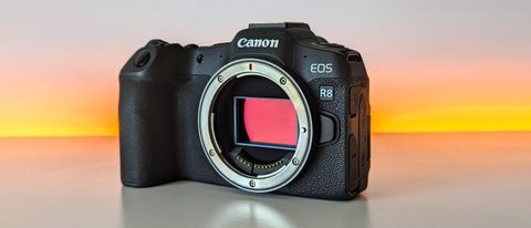 Canon EOS R8 set against a white backdrop with orange glow