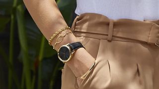 Woman wearing Garmin Vivomove watch