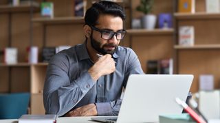 Man watching video on his laptop in office