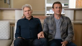 From left to right: Harrison Ford looking upset about the fact that he's holding Jason Segel's hand.