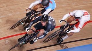 Three cyclist sprint to the finish on a wooden oval track at the Track World Championships 