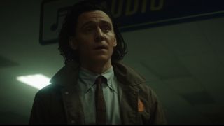 Tom Hiddleston' Loki stares at someone off camera in episode 2 of his self-titled TV show